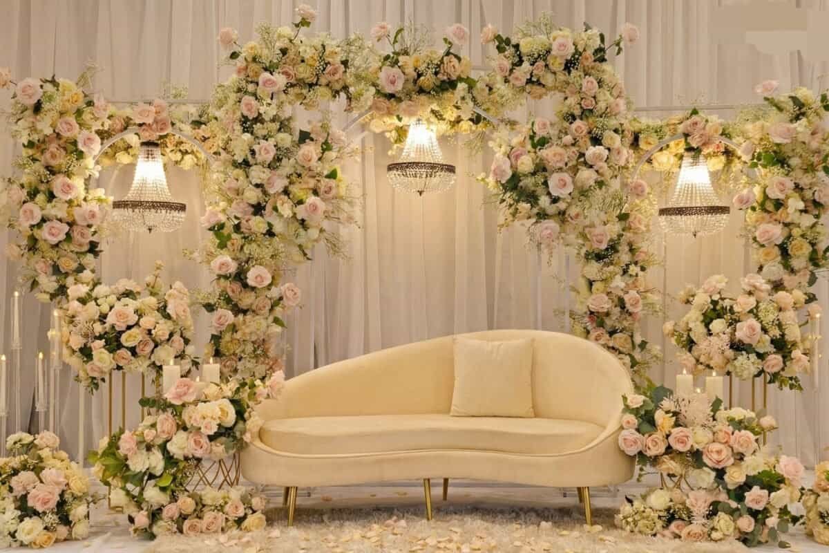 Beautiful wedding stage decorated with a floral arch and elegant lighting in Melbourne.