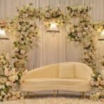 Beautiful wedding stage decorated with a floral arch and elegant lighting in Melbourne.