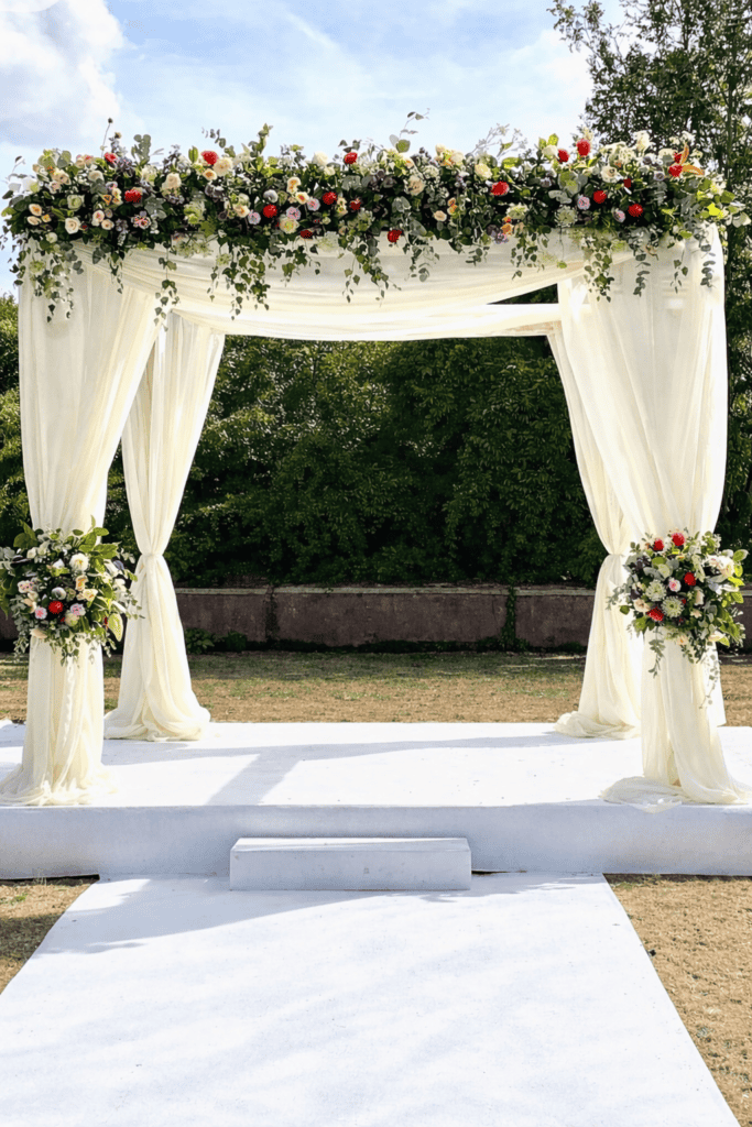 Wedding arch decorated with lush flowers for a luxurious Melbourne wedding.